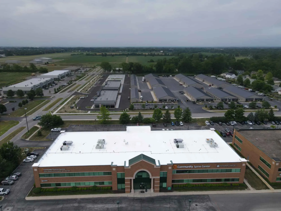 Aerial view of a medical office facility's roof repaired by Seamless Roofing