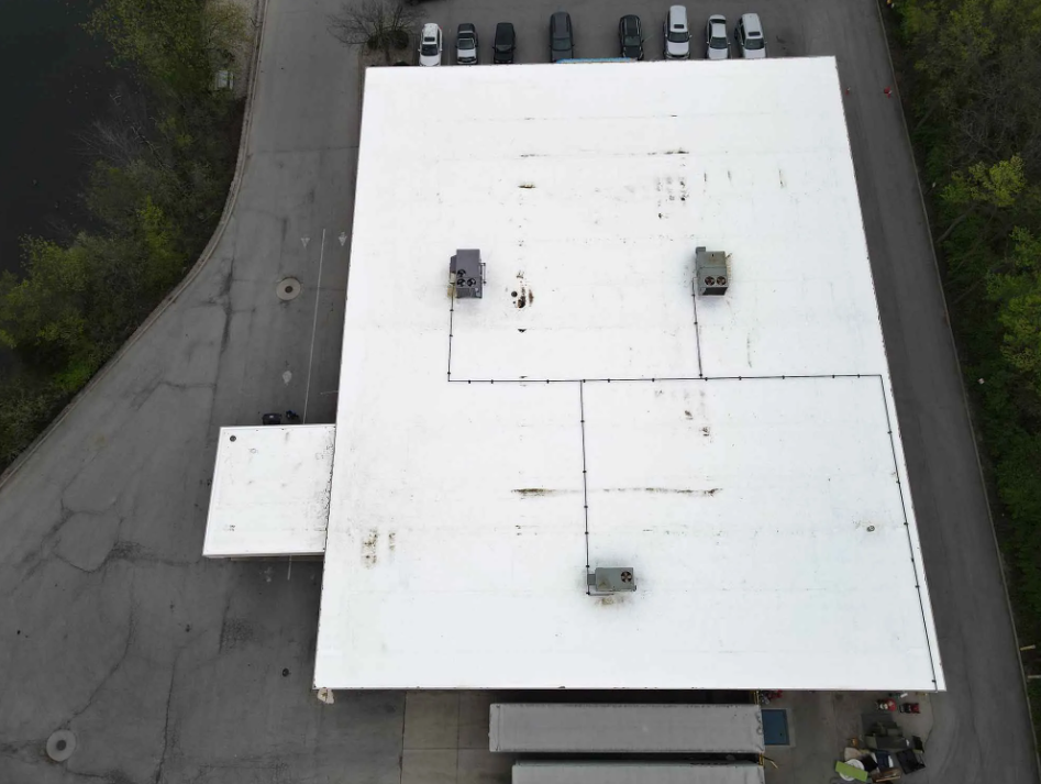 Aerial view of a retail building with a restored roof