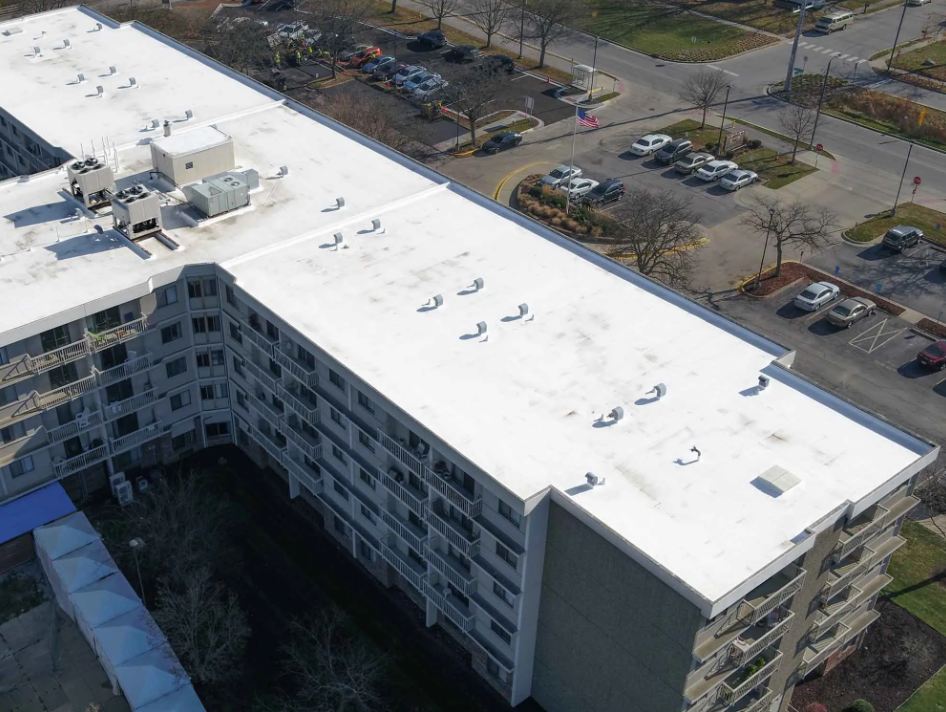 Aerial view of senior living facility's roof repaired by Seamless Roofing