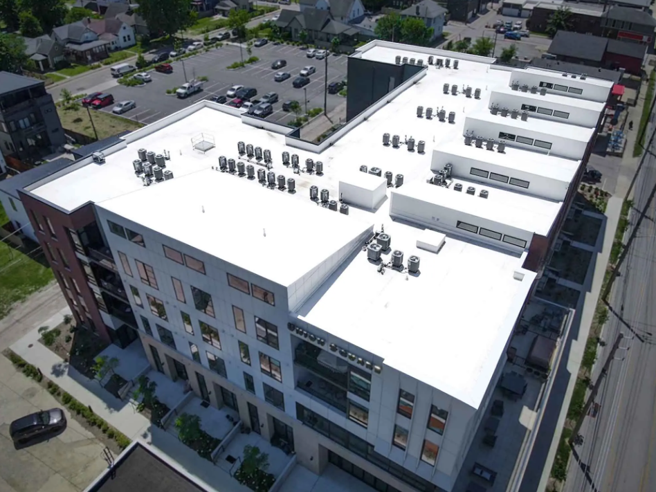 Aerial view of luxury apartment building with a new roof construction completed
