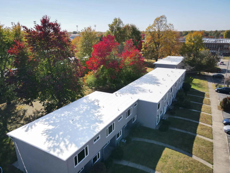 Aerial view of a multi-family home with a roof restored by Seamless Roofing