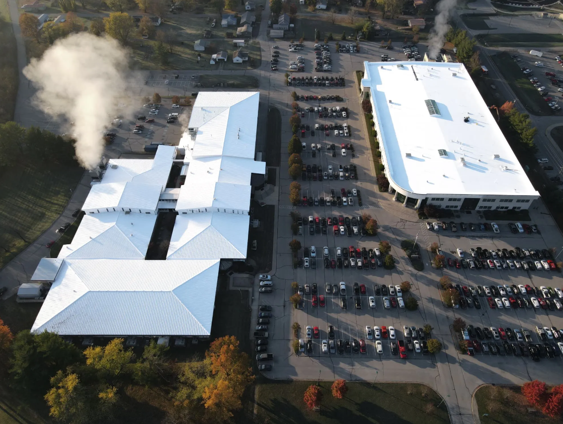 Aerial view of a pharmaceutical plant with a recently completed roof recovery and restoration